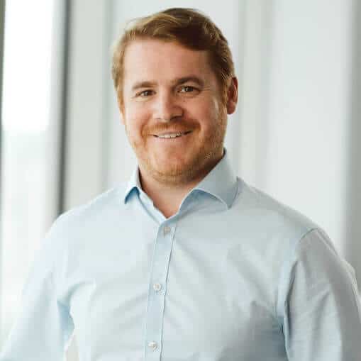 smiling financial advisor with light colored shirt