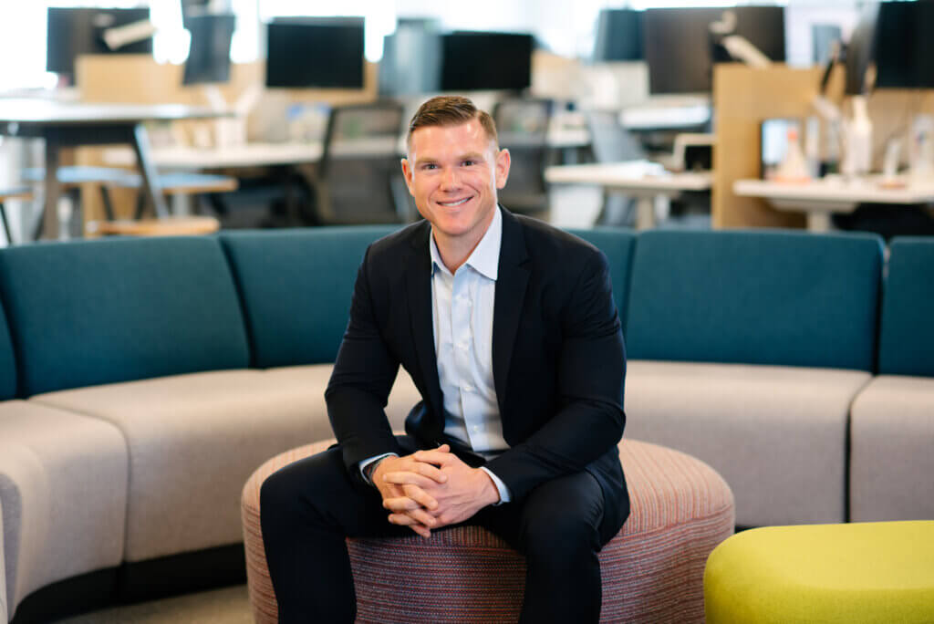 man in navy suit with light blue button up
